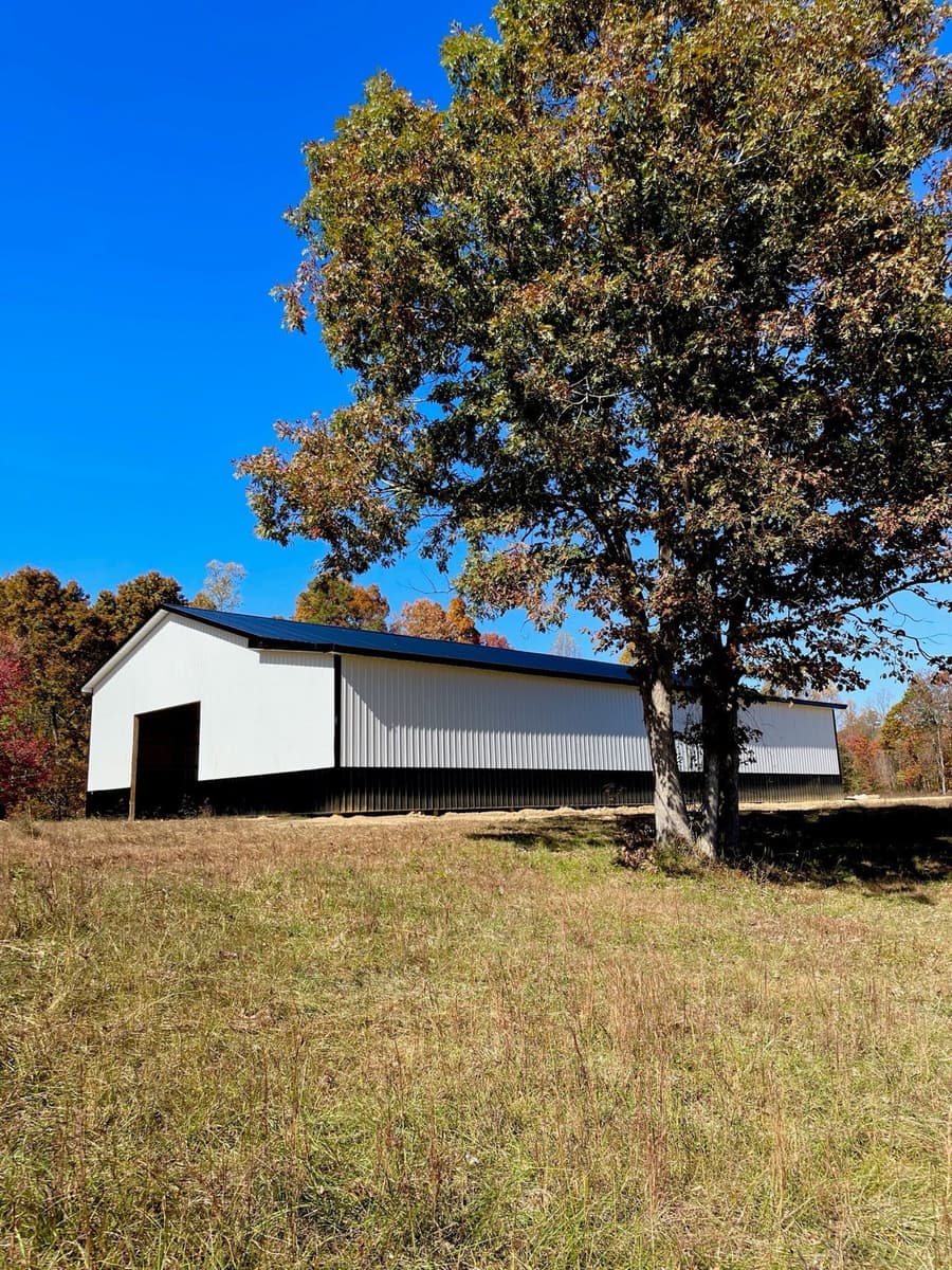 White metal building with black wainscot